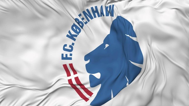 A waving flag featuring the emblem of F.C. København, with a blue lion silhouette and red text on a white background. 