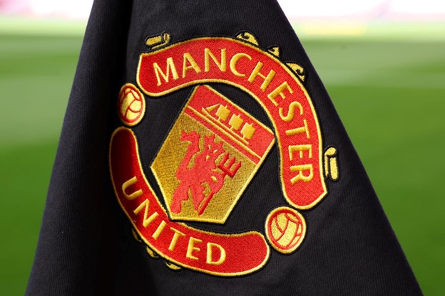 Close-up of the Manchester United emblem embroidered on dark fabric