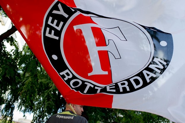 A Feyenoord Rotterdam flag waving, displaying the club’s logo prominently.